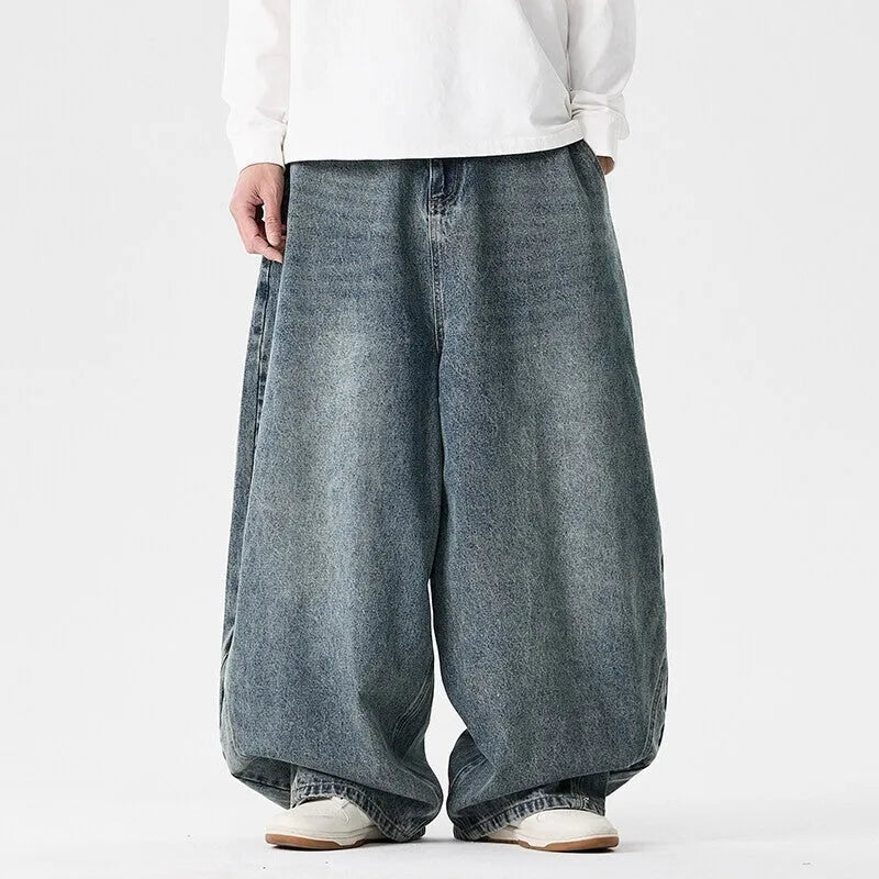 Man wearing plus size light blue wide leg baggy jeans, low waist straight leg casual style.