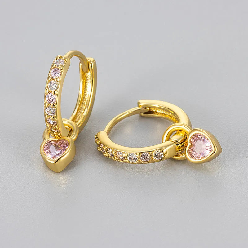 Women's heart-shaped drop earrings with coloured zircon or corundum stone in gold or white gold tone.