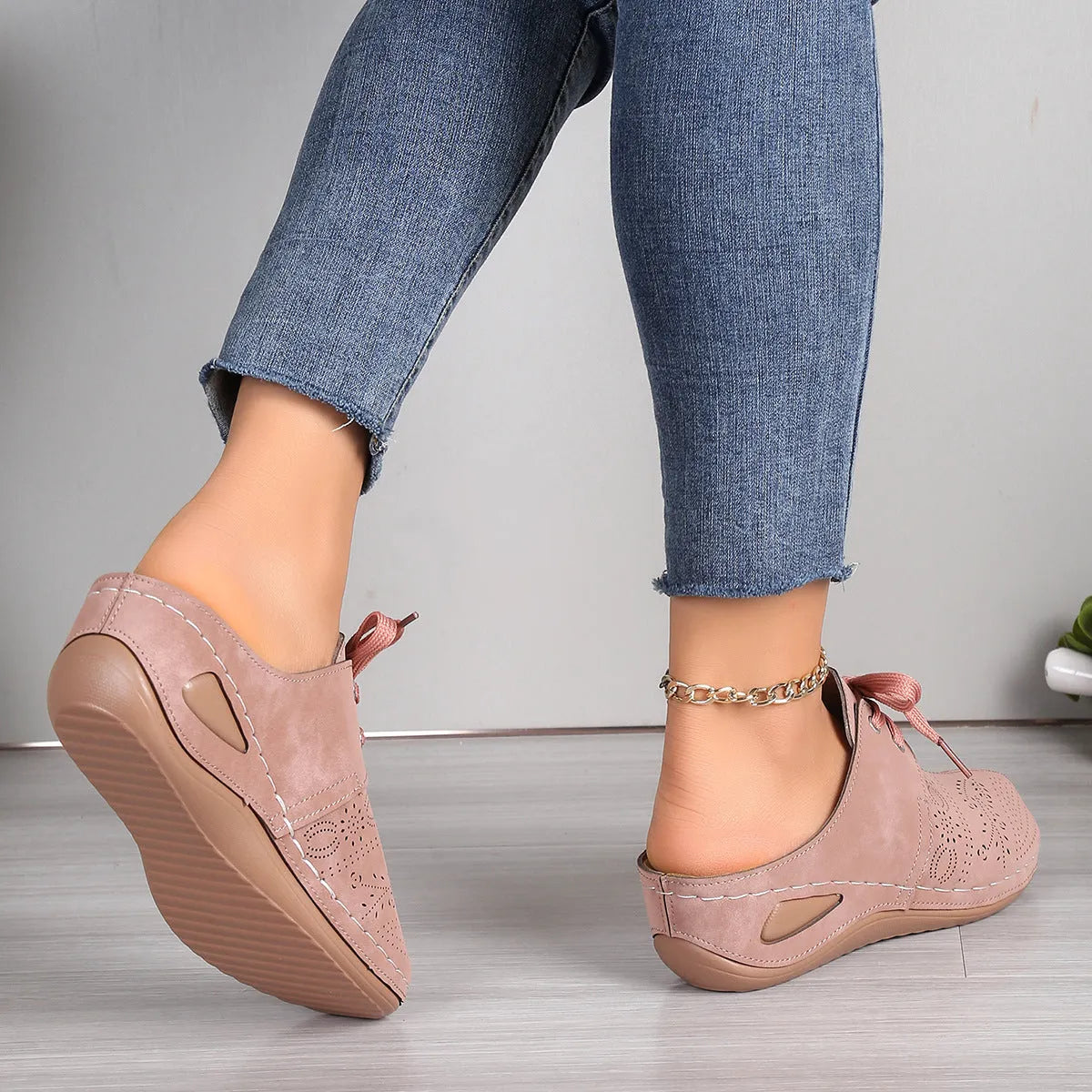 Women's black lace-up wedge slippers with a suede upper and rubber sole on a white background.