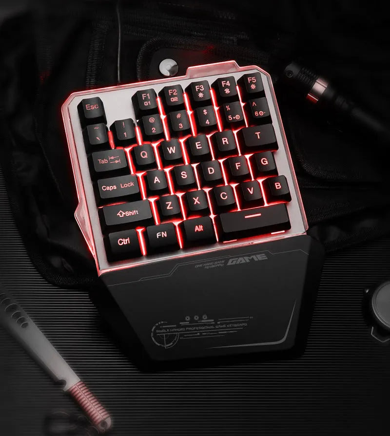 Black G40 Flow one-handed mechanical gaming keyboard with RGB backlit keys on a desk.