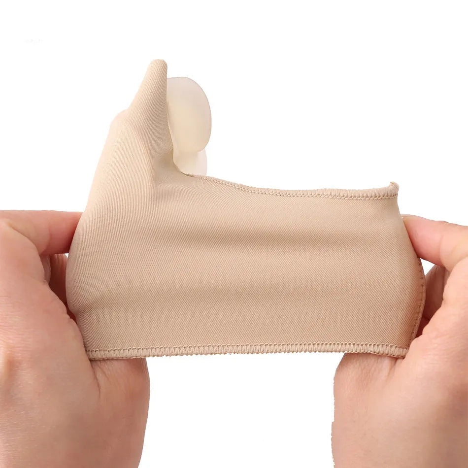 Corrective toe socks with a silicone gel bunion pad and toe separator on a grey background.