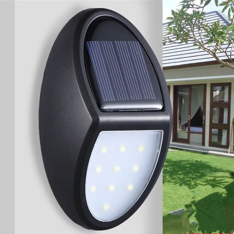 Black rectangular LED solar wall light mounted on an outdoor surface