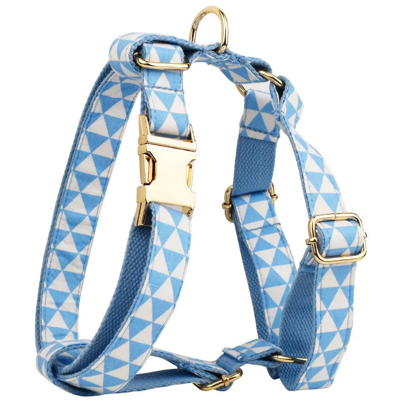 Blue triangular ring pattern dog accessory set with collar, leash, bow, and vest