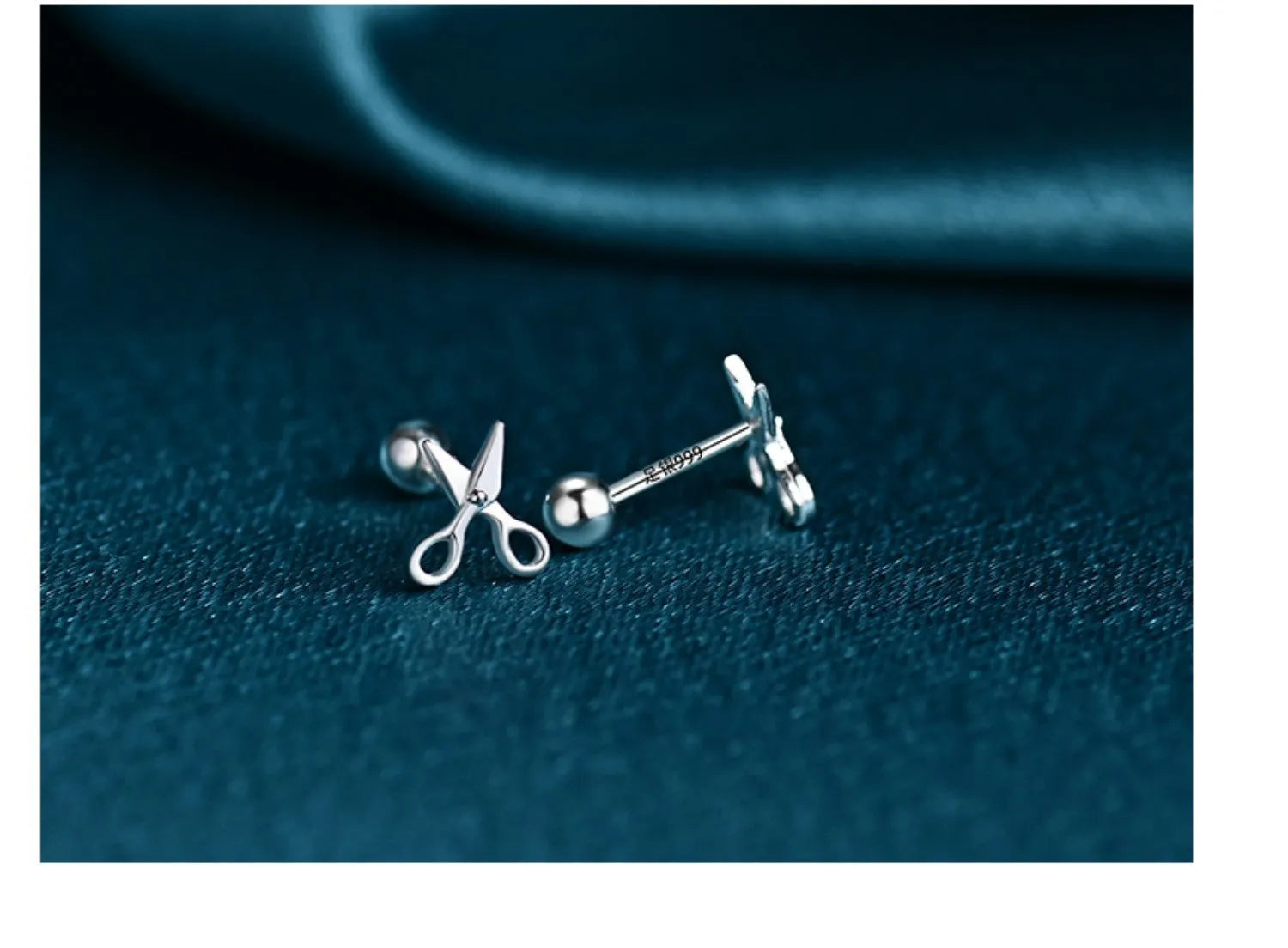 A pair of pure silver screw-back earrings for women with a mini scissors design on the fastening.