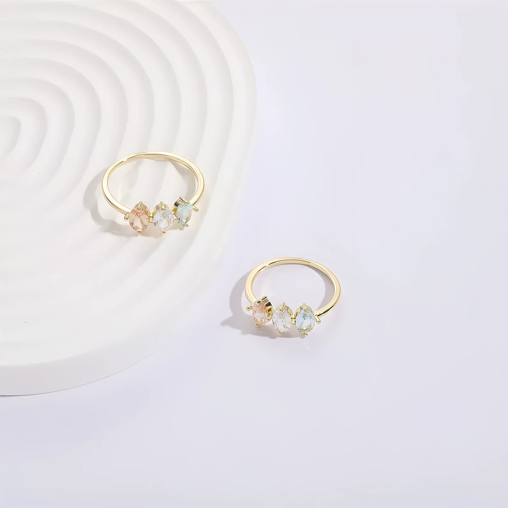 Geometric triangle copper ring with horse eye motif, tricolor zircon, and gold electroplate finish.