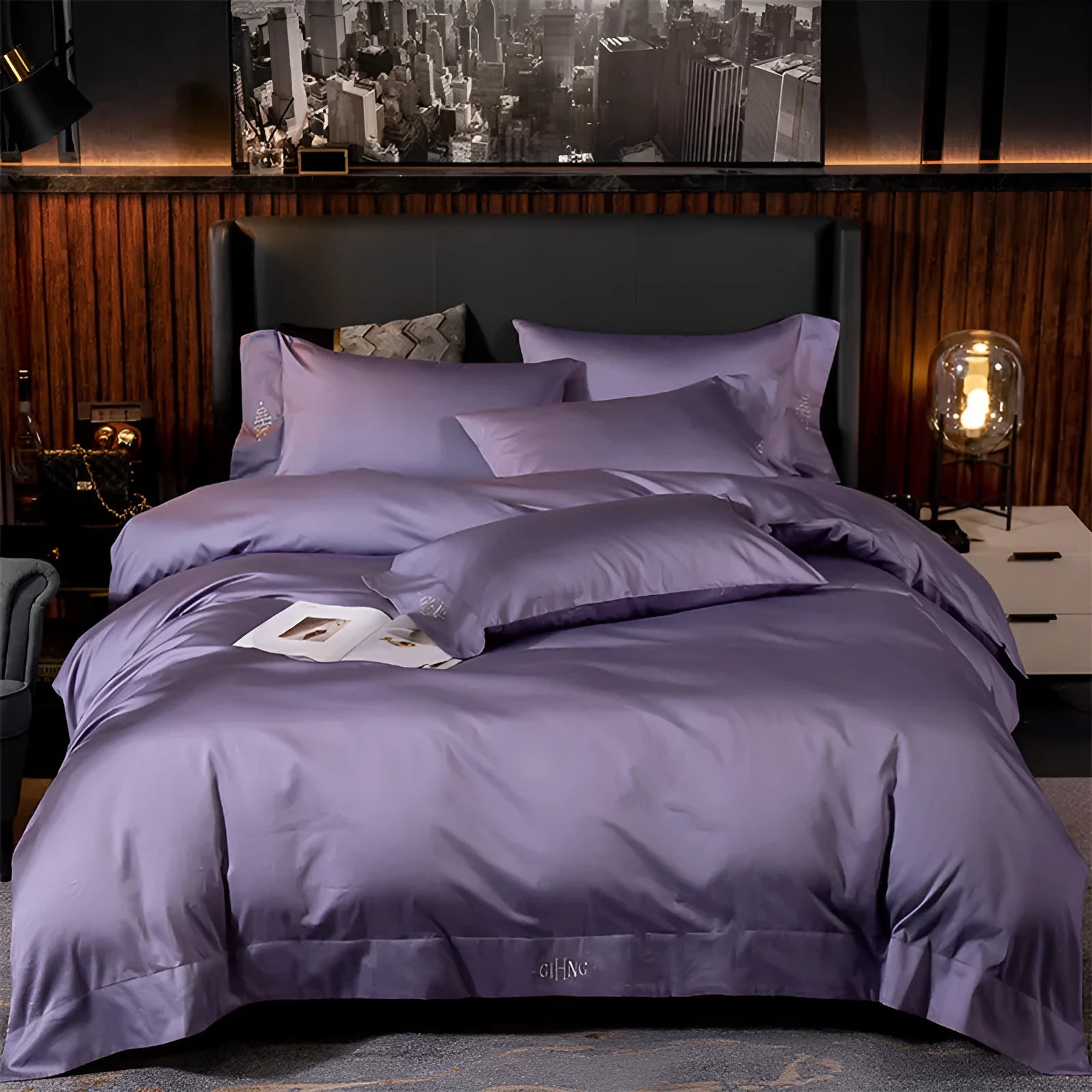 Four-piece cotton satin quilted bedding set with duvet cover, sheet, and pillowcases in a bedroom setting