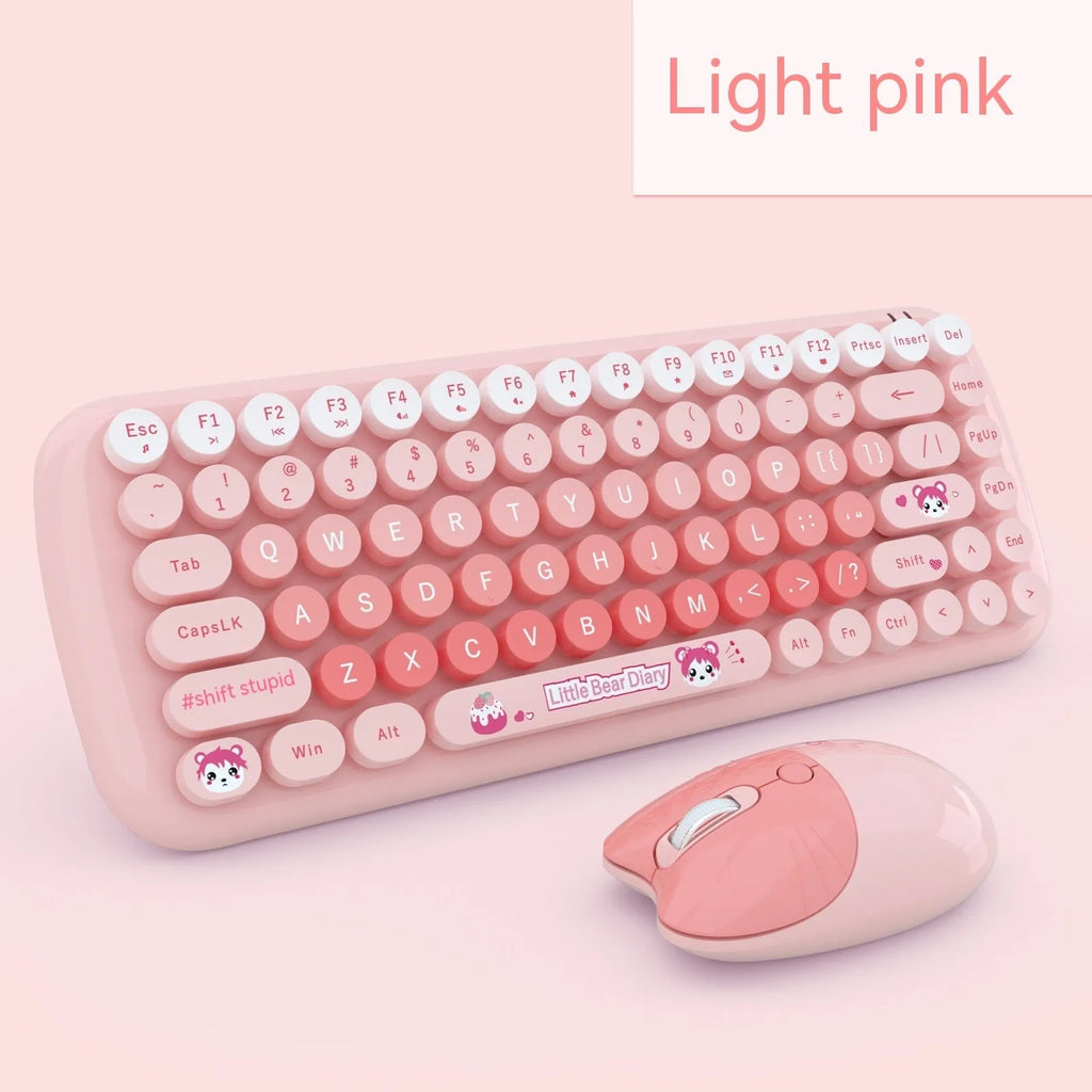 Pink mini wireless keyboard and mouse set with cute cartoon design on a desk.