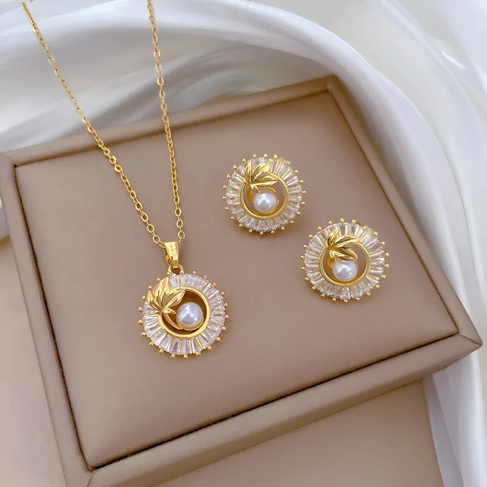 Geometric fashion jewellery set with gold plated copper detailing on titanium steel chain