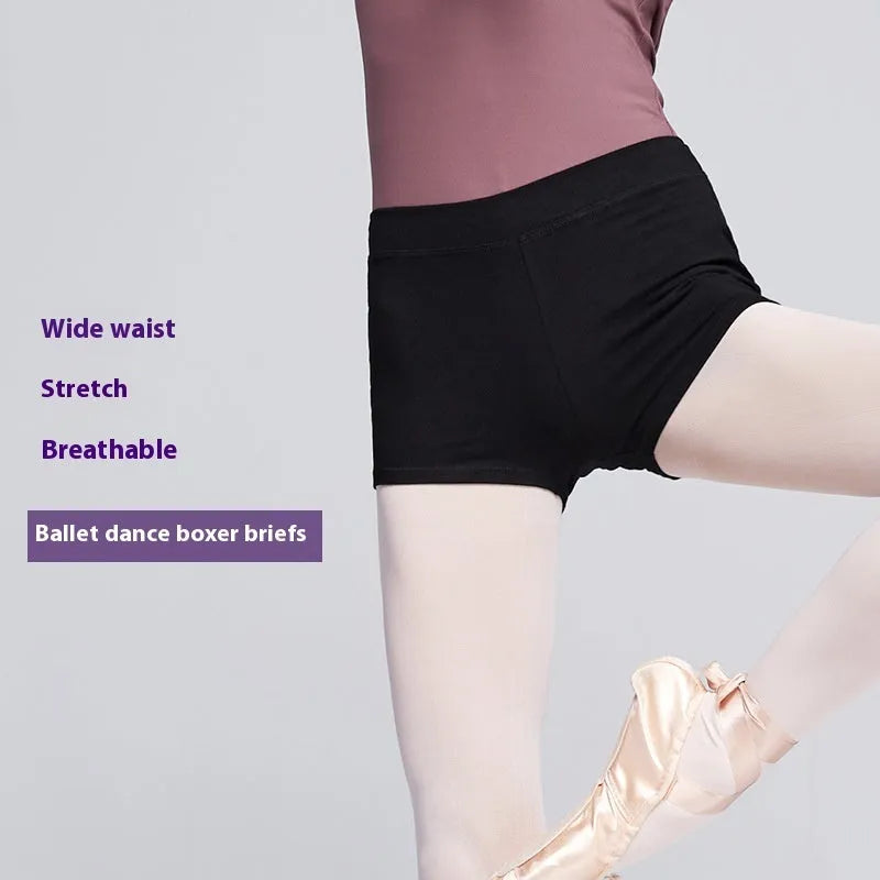 Black cotton women's ballet practice trousers laid flat, showing solid colour and fit for dance exercise.