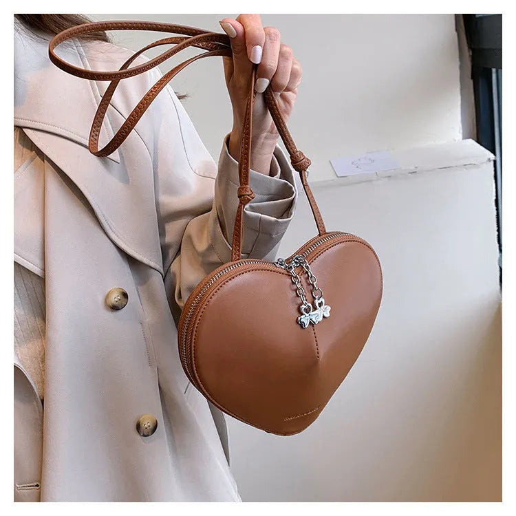 Women's PU leather heart shape crossbody bag in milky white with sewing line design and single shoulder strap