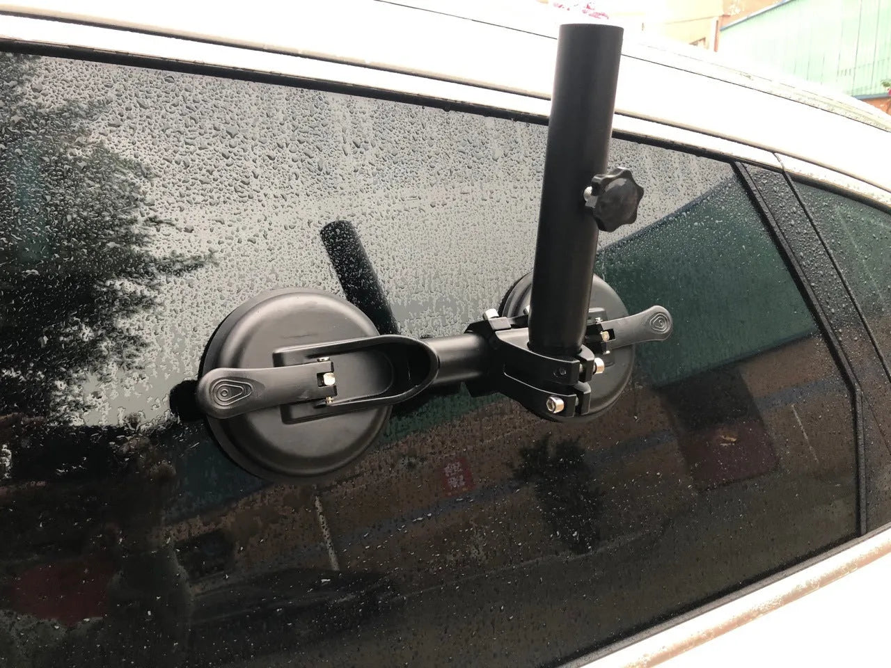 Black off-road car flagpole sucker base with round glass suction cup and rubber disc body.