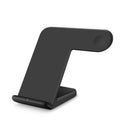 Black or white wireless phone charger with USB-C cable and UK power adapter on desk