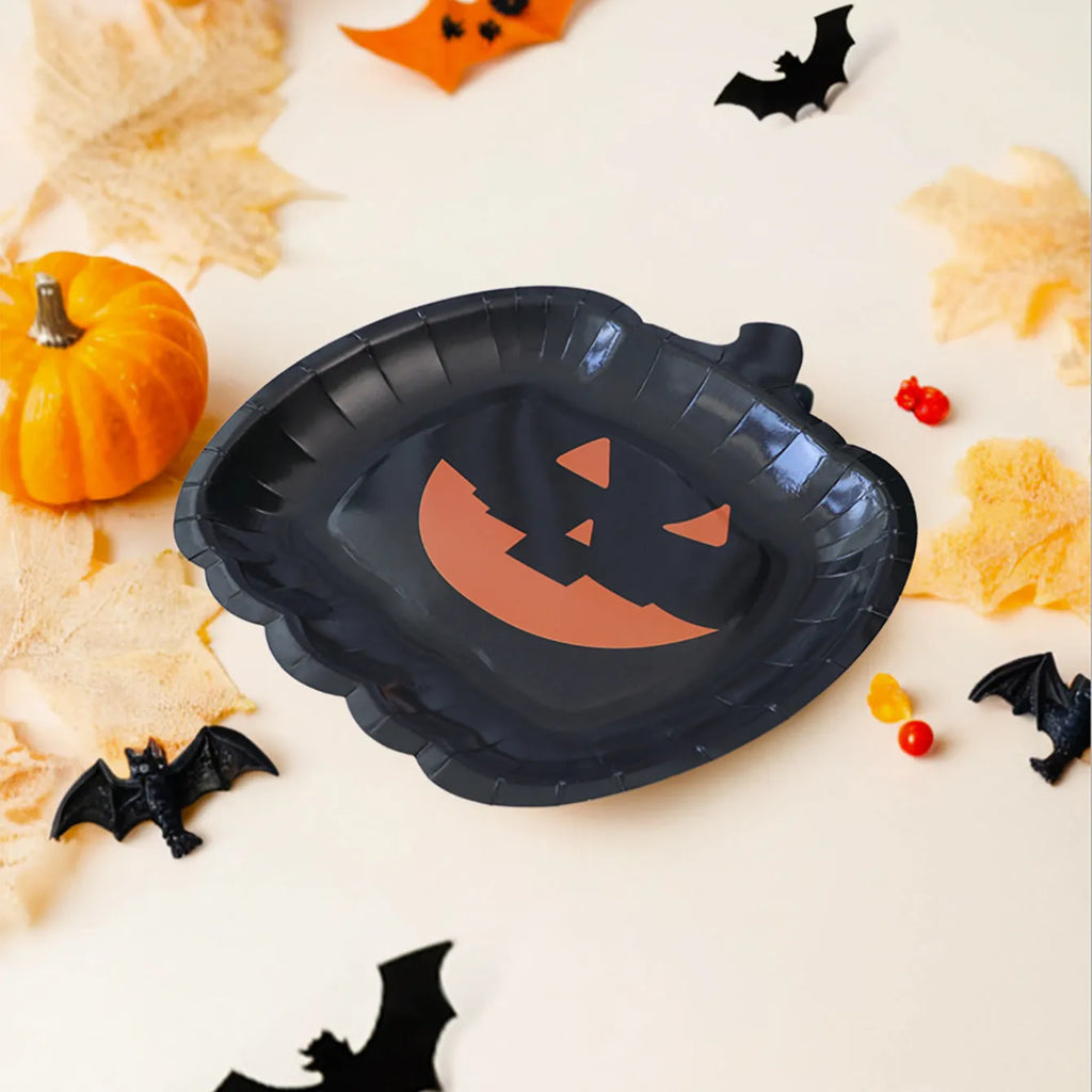 Black Halloween paper plate with pumpkin design, 9 inches in diameter.