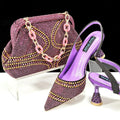 Women's pointed toe high heel shoes with rhinestones and matching small bag in blue.