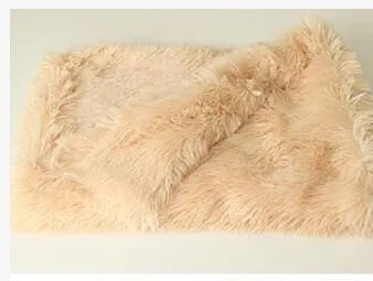 Soft long plush dog blanket in light grey, shown folded with size options S, M, L.
