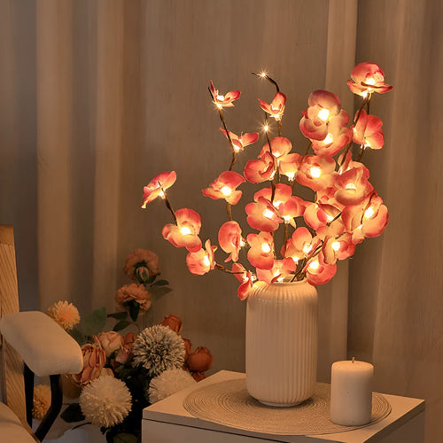 Pink fabric and plastic Phalaenopsis orchid branch LED light, 65cm long, with warm glowing lights.
