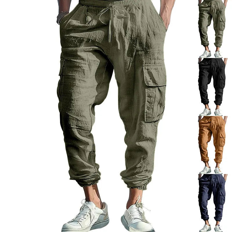 Man wearing loose khaki linen casual trousers with a drawstring waist and ankle-tied legs.