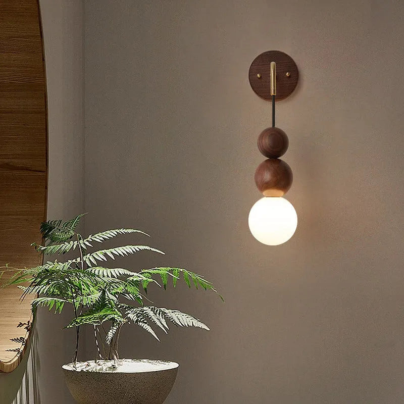 Wood and copper cylindrical wall lamp with suspension wire, showing Walnut and copper colour variants.