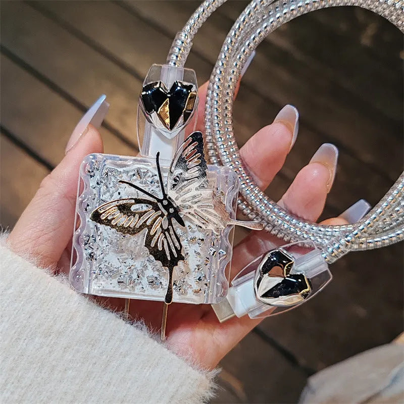 Three-dimensional butterfly USB cable protection sleeve in butterfly colour with silver foil finish on a white background