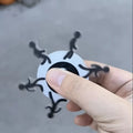 Acrylic stickman running fingertip gyro in colourful runner design on a plain background