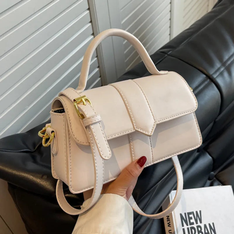 Women's beige PU messenger bag with sandwich pocket and file organiser interior.