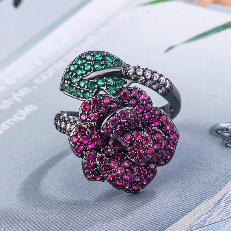 Gold-plated copper ring with geometric flower design and simulation red corundum in black gold finish