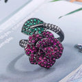 Gold-plated copper ring with geometric flower design and simulation red corundum in black gold finish