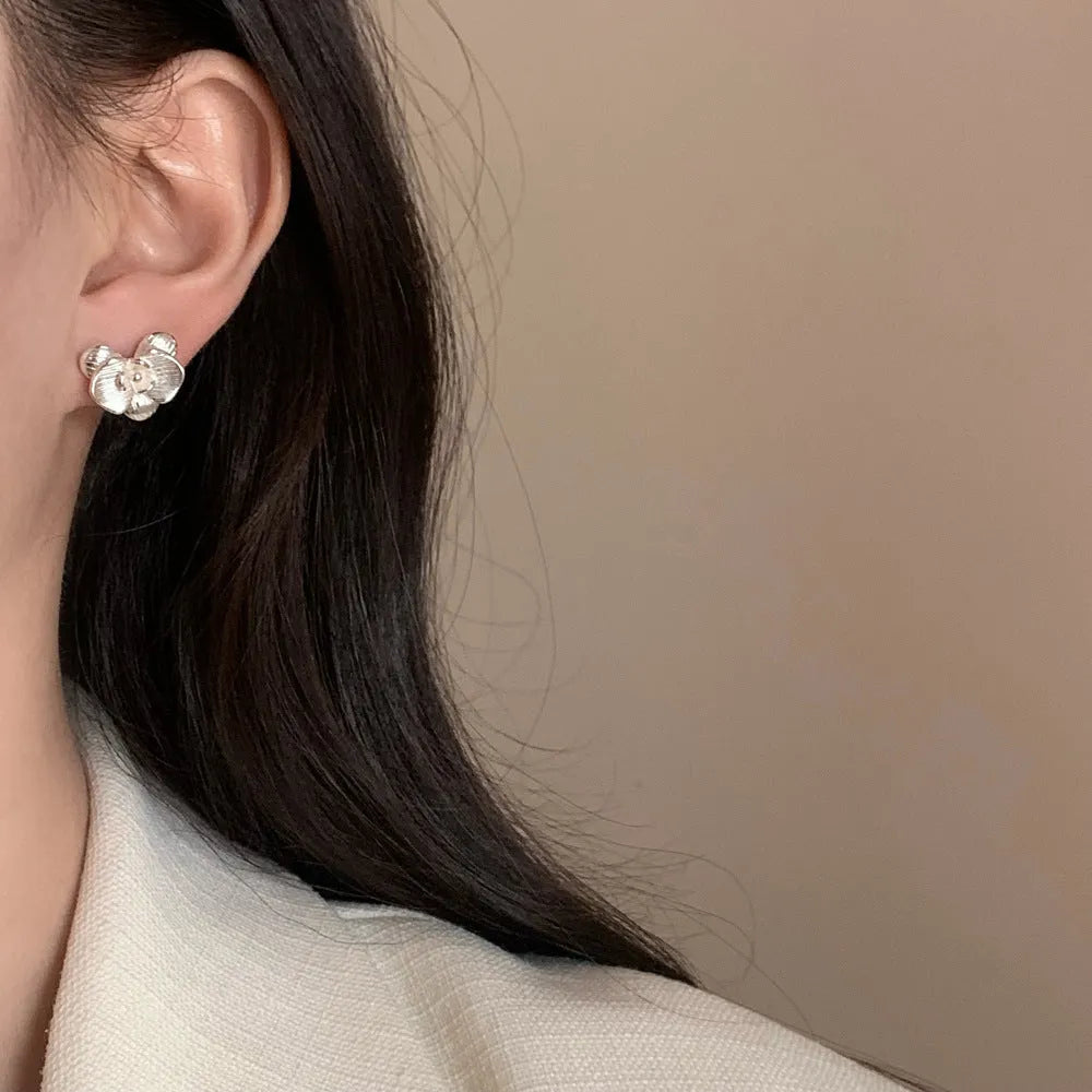 Retro style flower earrings with petal detailing in gold or silver electroplated finish on copper