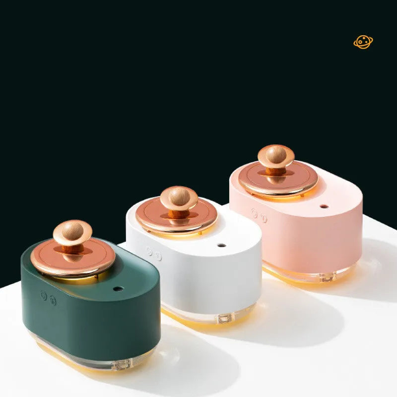Green rotating planet-shaped USB humidifier with night light on a wooden desk