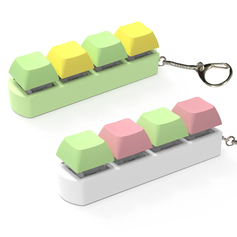 Four-key mechanical keyboard switch shaft tester with coloured keycaps and transparent base on a desk.