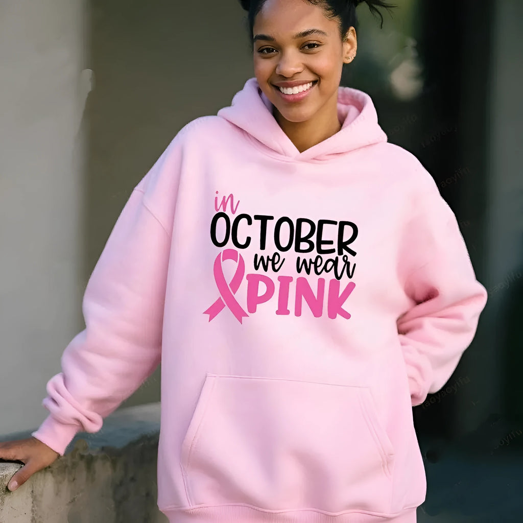 Woman wearing a pink retro pattern sweatshirt hoodie with side pocket.