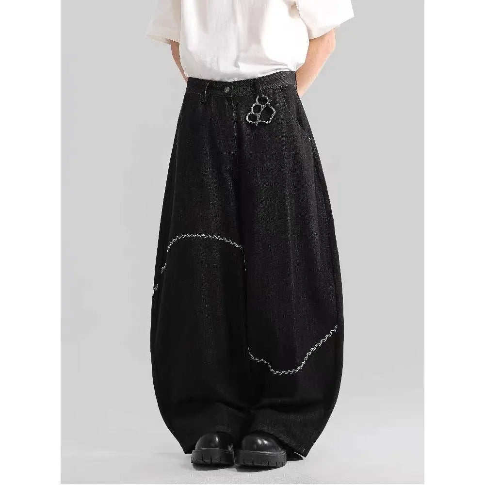 Black straight-leg jeans trousers with mid waist and zip placket closure on teenage model
