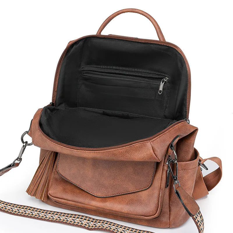 Retro women's backpack with two-tone fringe, soft PU outer, multiple compartments, available in various colours.