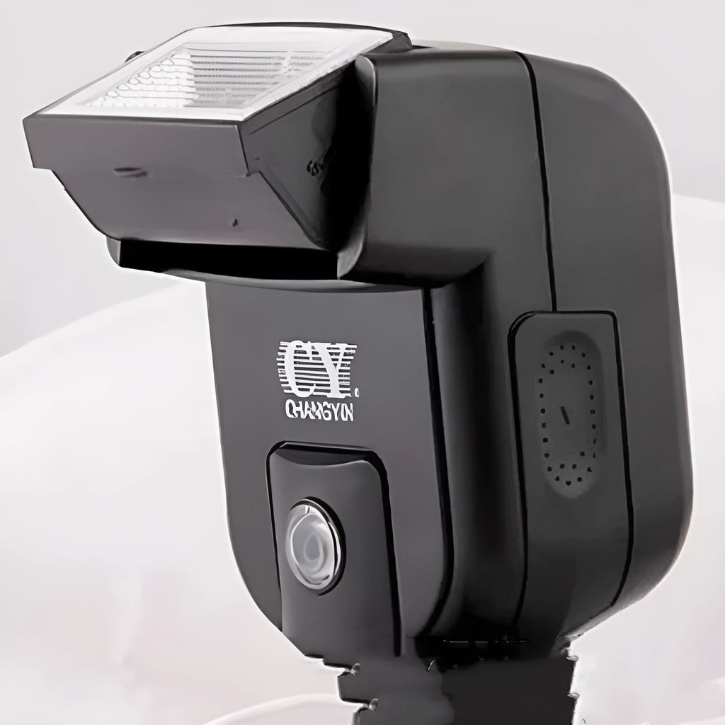 Silver SLR camera flash unit with tilt mechanism mounted on camera hot shoe