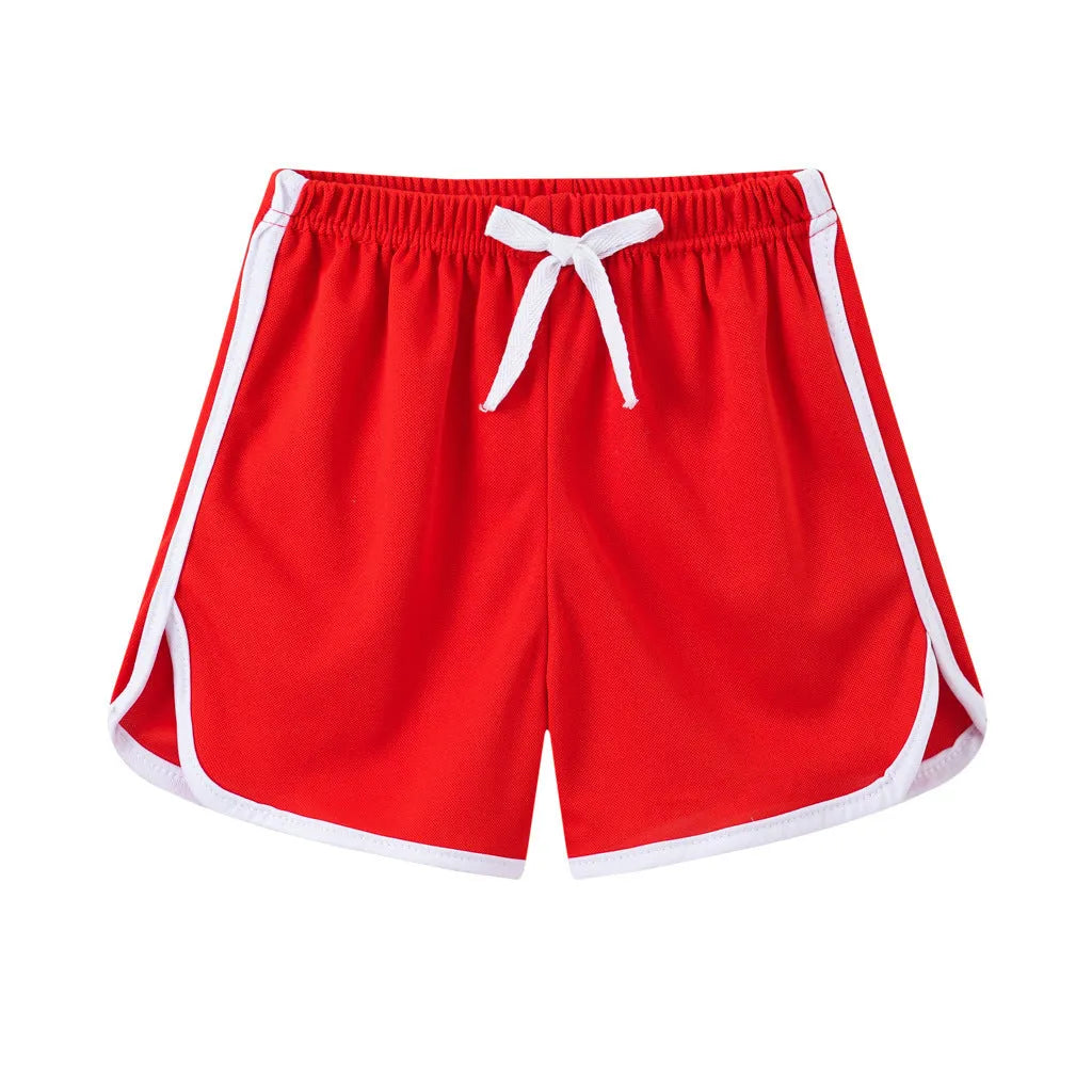 Children's colourful polyester shorts with elastic waistband, showing patterns like stripes, pineapples, and kittens.