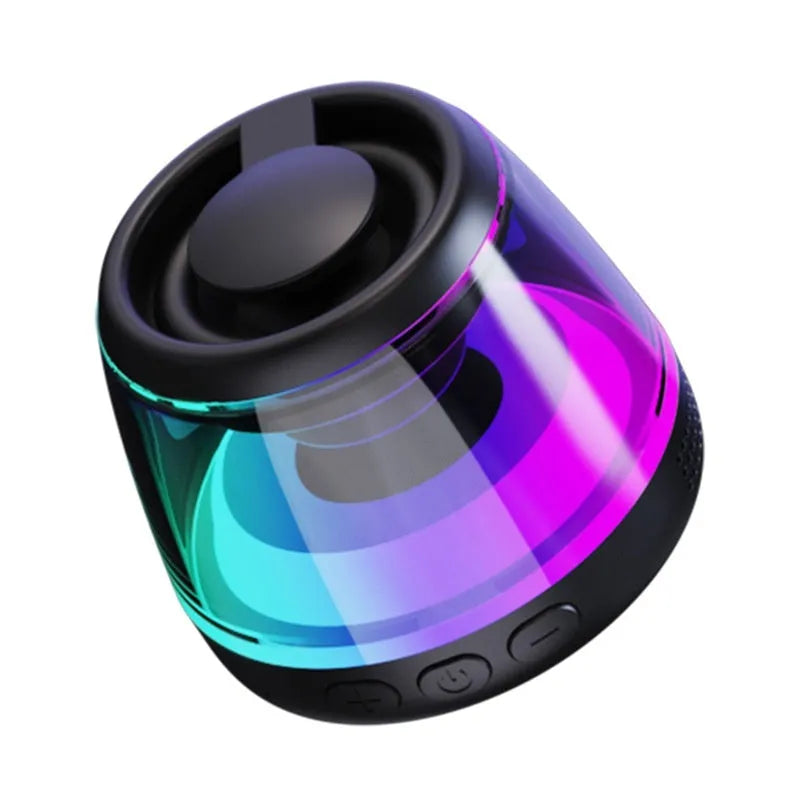 Portable white or black Bluetooth speaker with ambient lighting and magnetic design on a desktop