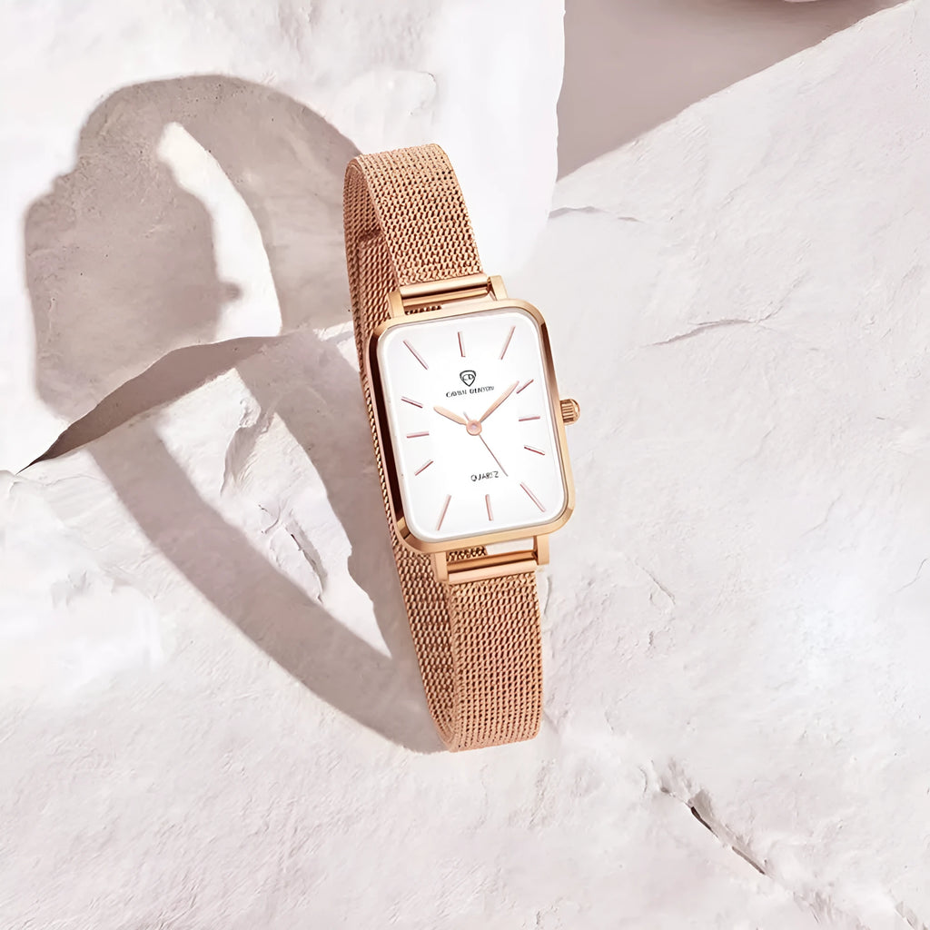 Women's rose gold waterproof watch with a woven steel strap and quartz movement.