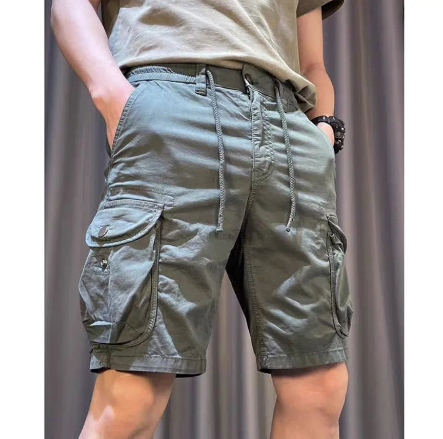 Loose straight-leg overalls pants in khaki with multiple cargo pockets on the legs.
