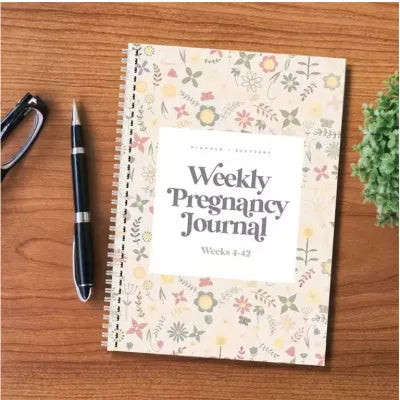 A5 pregnancy weekly diary notebook open showing weekly pregnancy journal pages