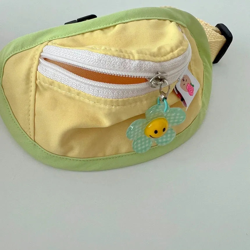 Powder blue messenger bag-style dog poop bag holder with adjustable strap and multiple pockets.
