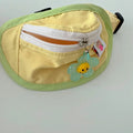 Powder blue messenger bag-style dog poop bag holder with adjustable strap and multiple pockets.
