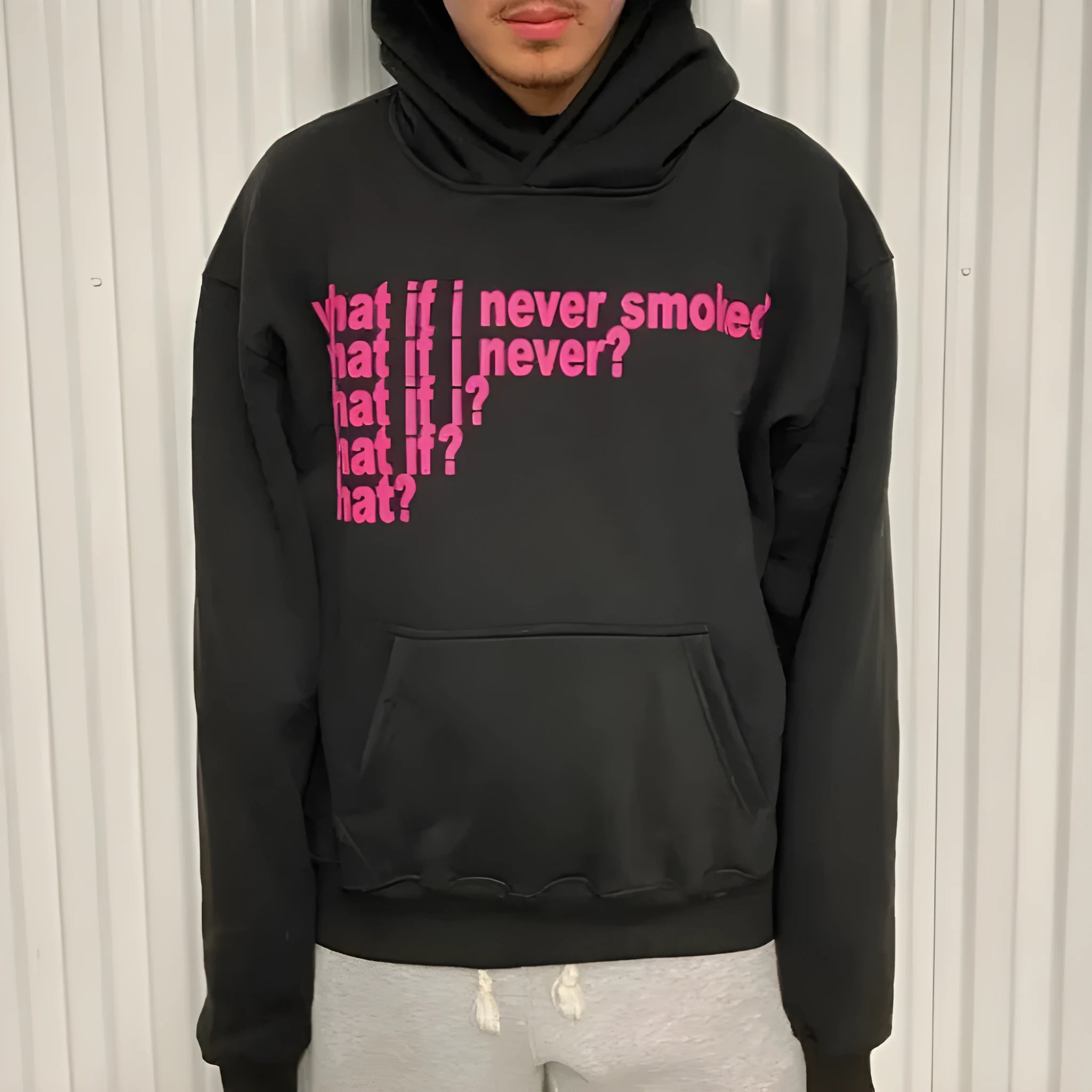 Black hooded sweater with white letter print pattern, hood up, front view