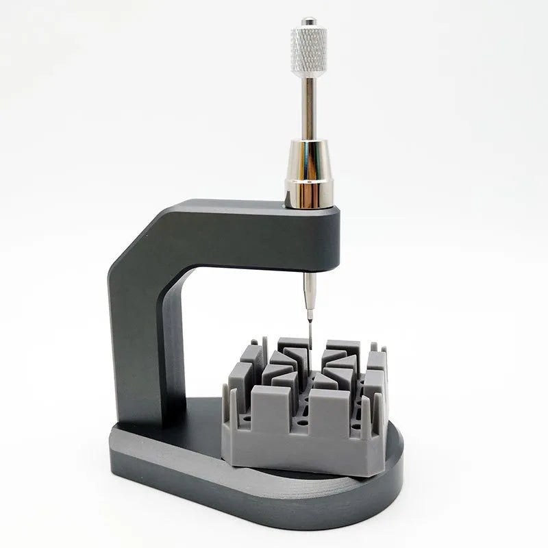 Silver-coloured press strap removal tool for watch and electronics repair.