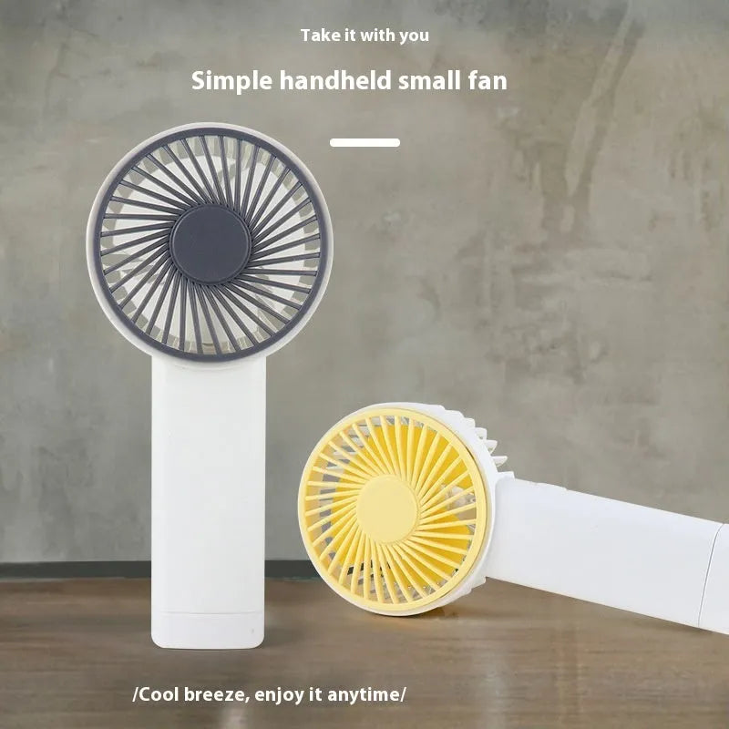 Outdoor portable USB rechargeable handheld fan with three plastic blades, available in multiple colours and cartoon designs