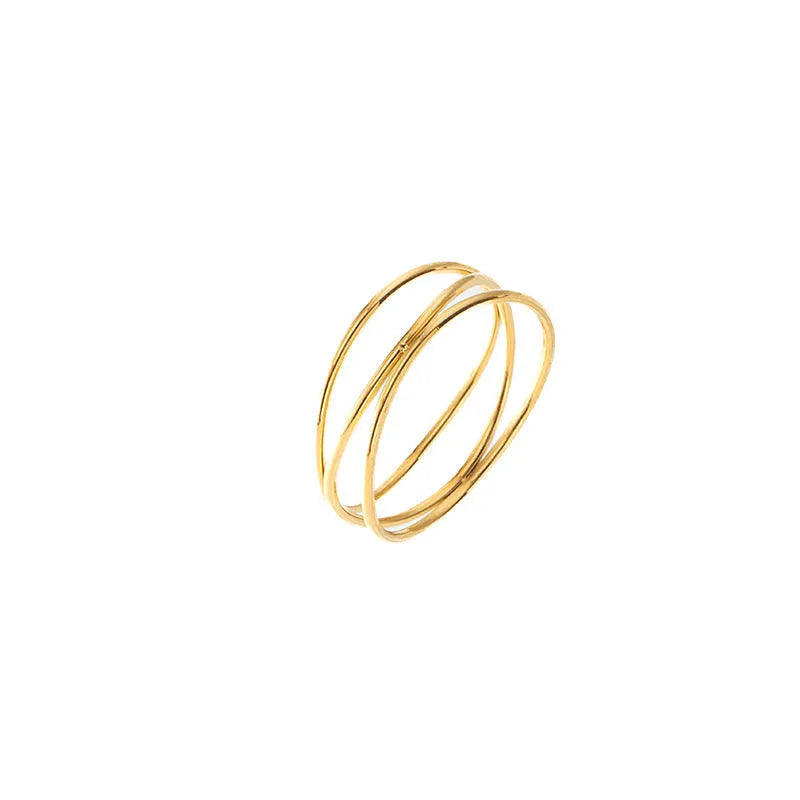 Gold geometric titanium steel coil ring showing three-layer bracelet-like design on a finger.