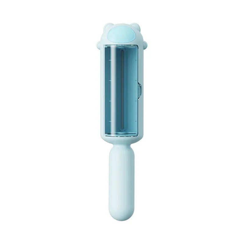 Blue reusable pet hair remover tool with a self-cleaning base on a fabric sofa.
