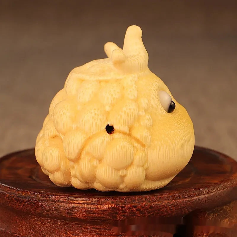 Solid bamboo carving of a cute Crown Princess Toad ornament with live eye detail.