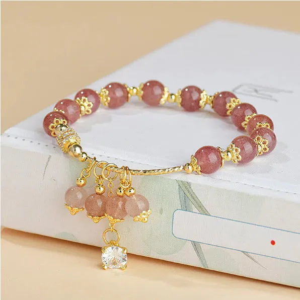 Pink strawberry quartz crystal heart-shaped women's bracelet with pearl accents.