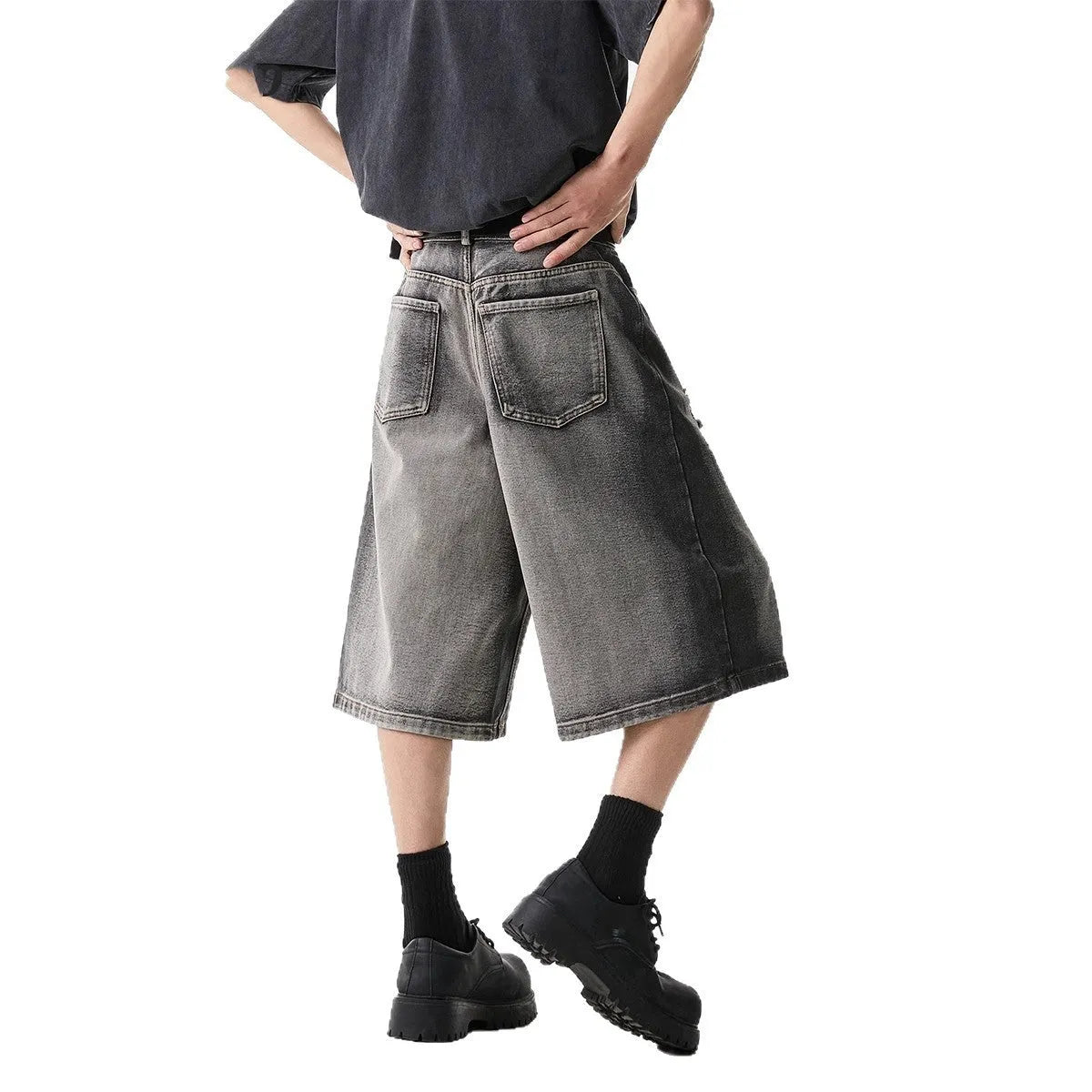 Grey distressed denim shorts with water washed finish and loose retro fit