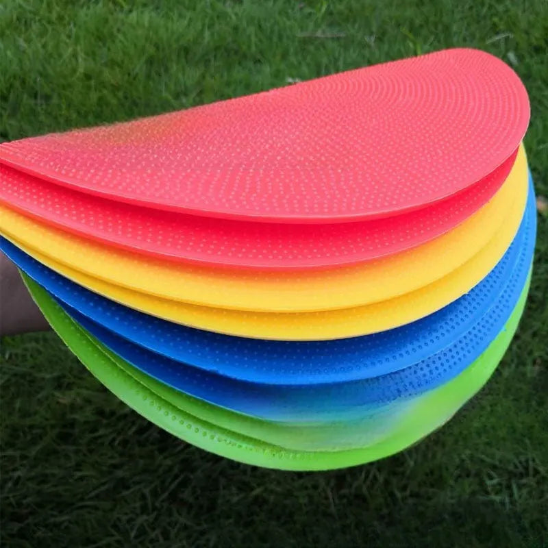 Soft coloured football training marker disc on grass field for target practice